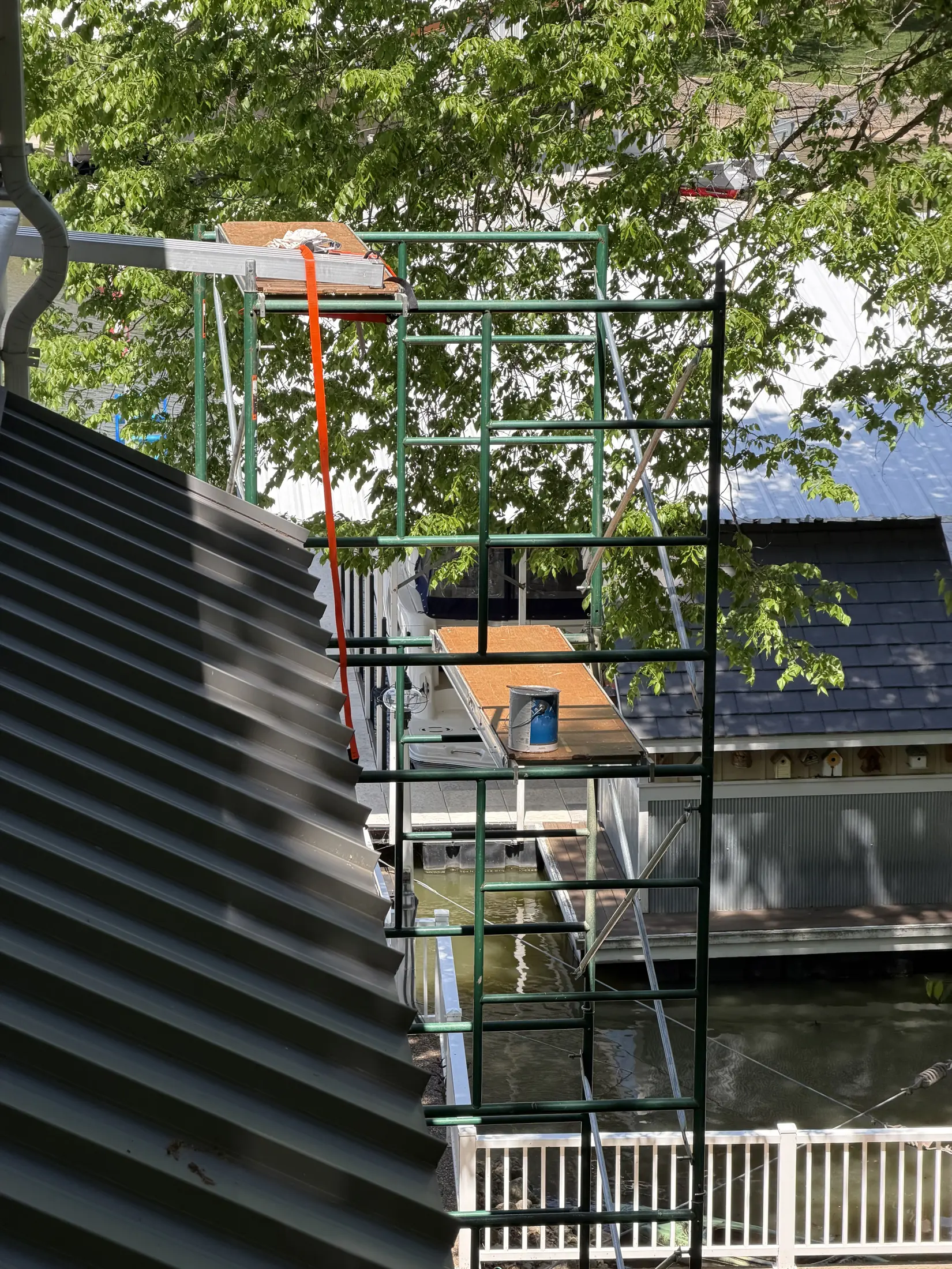 Exterior scaffolding beside a dark-sided building.