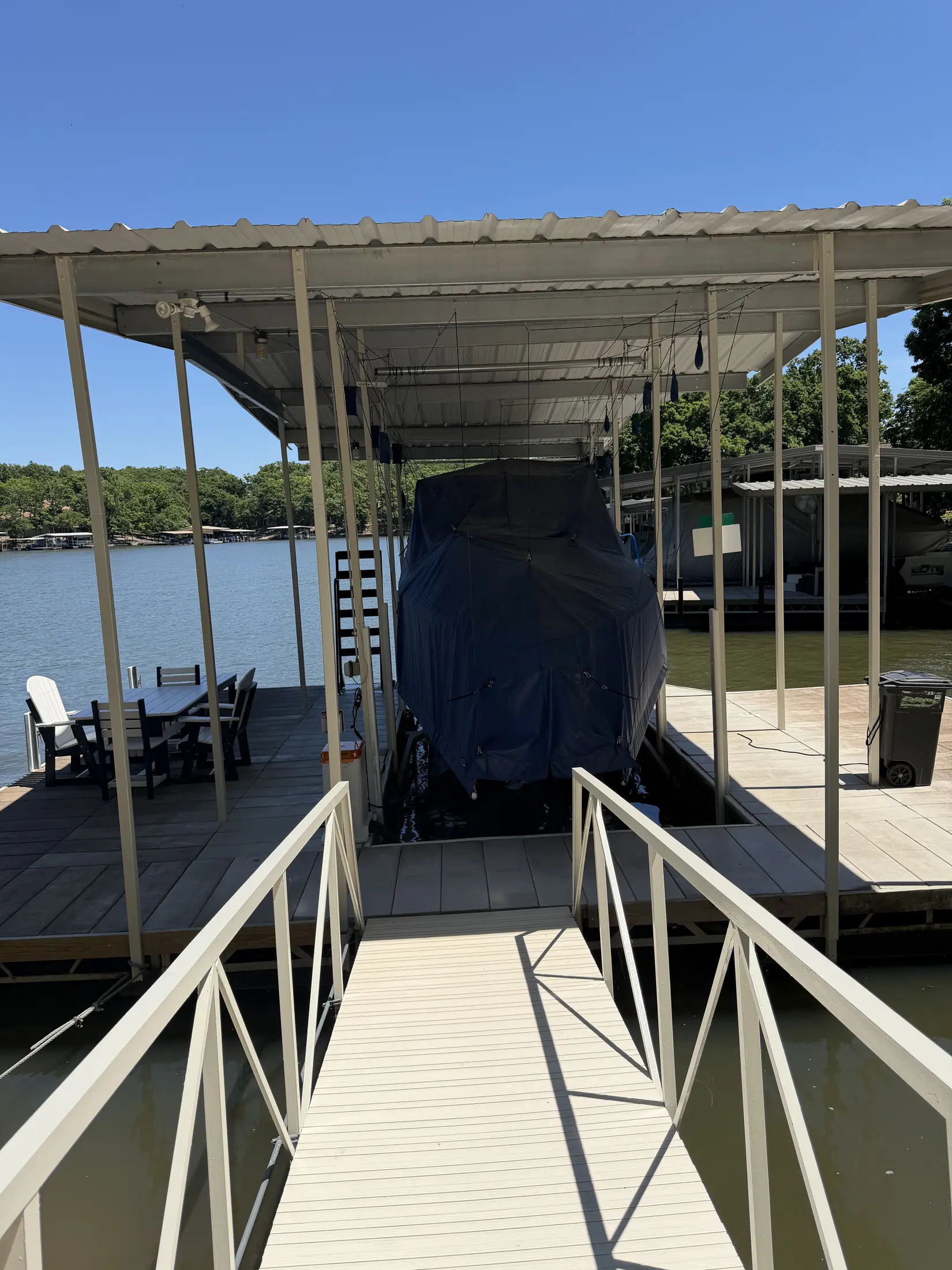 Covered dock walkway leading toward a boat slip at Lake of the Ozarks.
